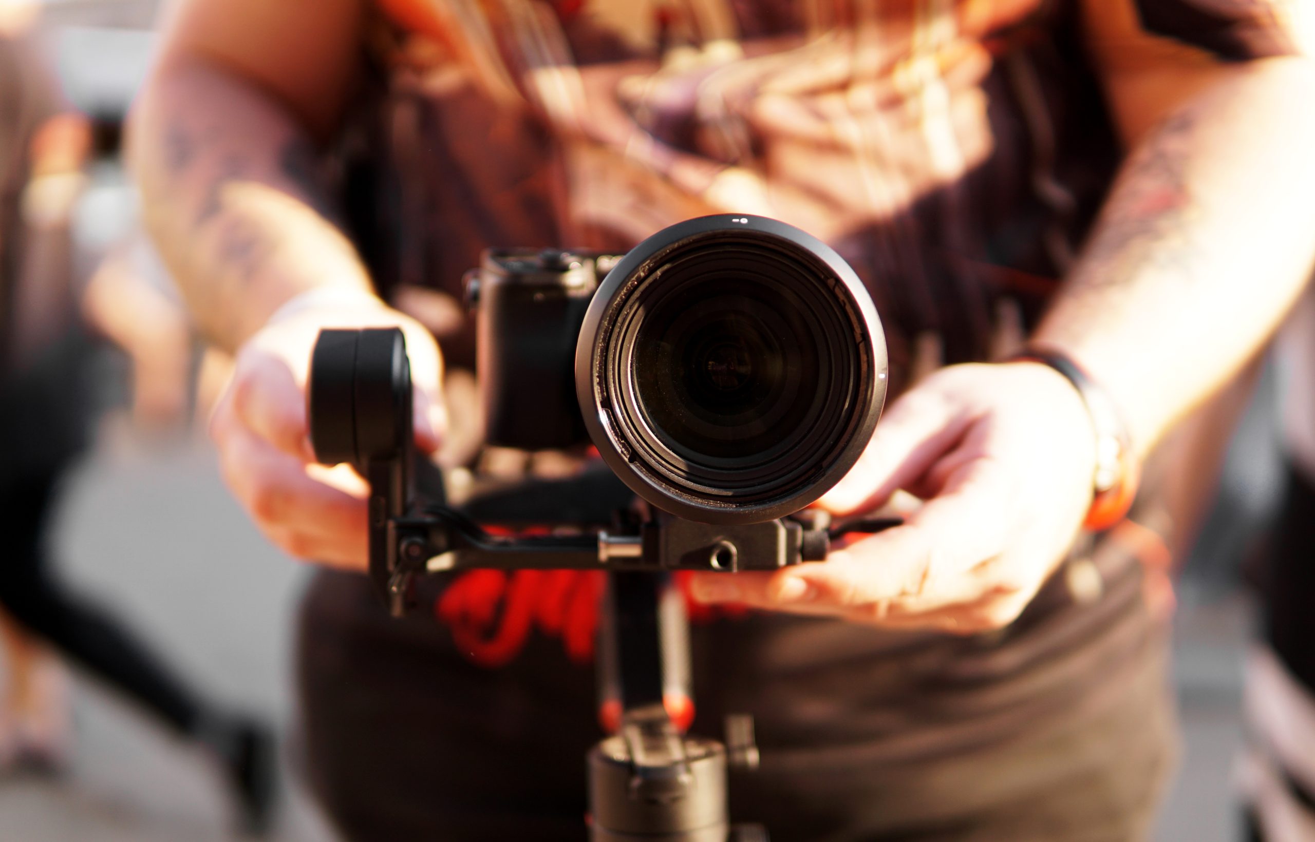 Homme tenant une caméra professionnelle prêt à capturer des images de haute qualité. Man holding a professional camera ready to capture high-quality images.